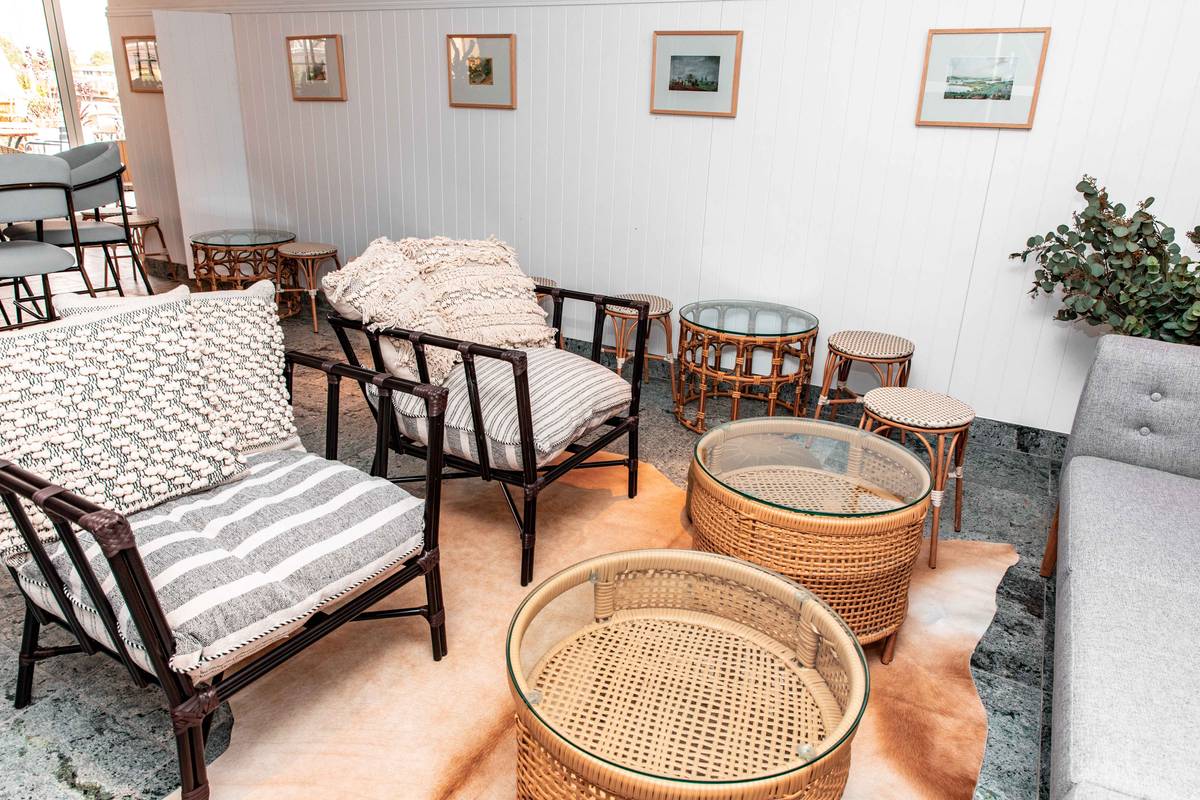 examples of bohemian decor featuring layered textiles, rattan furniture, and vibrant wall art in a sunlit living room